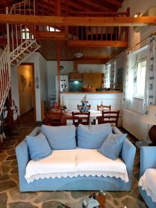 a living room with a white couch and a table at Villa Dimitra in Mourteri