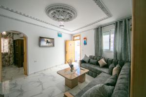 a living room with a couch and a table at A&C Blue Haven in Chefchaouen