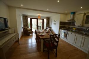 a kitchen with a table and chairs in a kitchen at Woodvilla Lodge in Kilmore