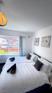 a large white bed in a bedroom with a window at Bright Housing in Newcastle upon Tyne