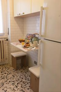 a kitchen with a counter with a refrigerator in it at Pichouse Brianza Varedo in Bovísio-Masciago Milanese
