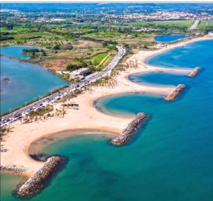 an aerial view of a beach with rocks in the water at Casa Louca in Saint-Aygulf