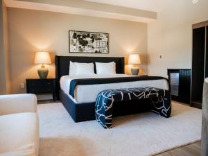 a bedroom with a large bed and two lamps at The Markham Hotel in Gulfport +31 photos