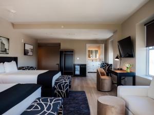 a hotel room with a bed and a couch at The Markham Hotel in Gulfport