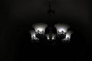 a chandelier with white lights in the dark at The Mukhiya Palace in Govardhan