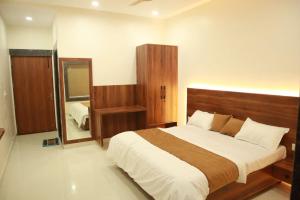 a bedroom with a large bed and a mirror at The Mukhiya Palace in Govardhan +19 photos