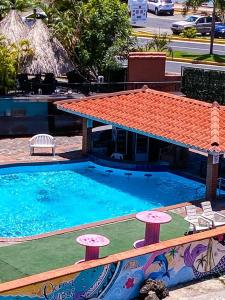 a swimming pool with chairs and a house at The Beach House in Panama City