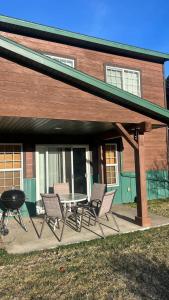 a patio with chairs and a grill in front of a house at Davis Beach Getaway Pet Friendly & Beach Access in McCall