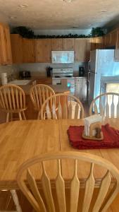 a kitchen with a wooden table and wooden chairs at Davis Beach Getaway Pet Friendly & Beach Access in McCall