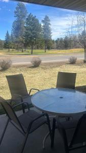two chairs and a table on a porch with a table at Davis Beach Getaway Pet Friendly & Beach Access in McCall
