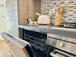 a dishwasher in a kitchen with a counter top at Alabastro 40 in Lido Adriano