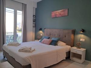 a bedroom with a large bed and a balcony at Poppy Beloni in Chania