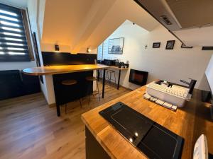 a kitchen with a counter and a table in a room at studio moderne in Barcelonnette