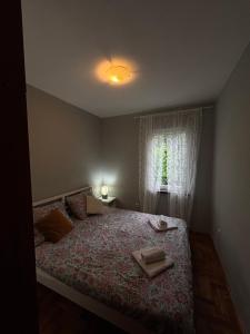 a bedroom with a bed with two towels on it at Apartment T&T in Lovran
