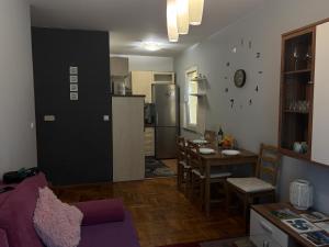 a living room with a kitchen and a dining room at Apartment T&T in Lovran