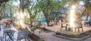 a group of tables and chairs with umbrellas at Mathios Hotel & Menafesha in Butajīra +3 photos