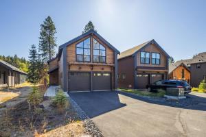 a house with a garage and a car parked in front at Cabin, Bonus Suite, Suncadia Pool Access in Cle Elum