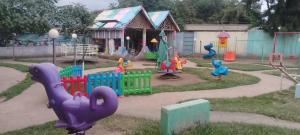 a childrens playground with a colorful play set at Mathios Hotel & Menafesha in Butajīra
