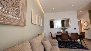 a living room with a couch and a table at Green Coast Escape in Palasë