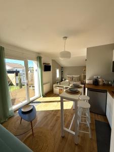 a kitchen with a table and chairs in a room at L'Anse Blanche in Biganos