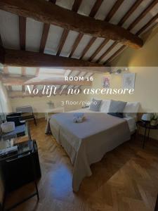 a bedroom with a bed with a sign on the wall at Apartment Hotel Marchesini in Ravenna