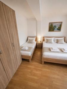 a room with two beds and a cabinet in it at Sasha Apartment and Swimming Pool in Gornje Selo