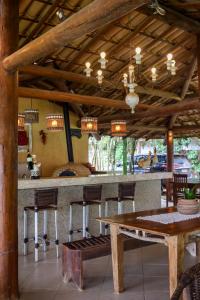 a kitchen with a bar with a table and chairs at Pousada Tetiaroa in Barra Grande