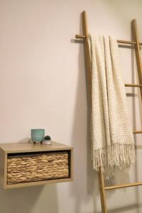 a towel hanging on a wall next to a shelf at Eftychia's Cozy Apartment in Sitia