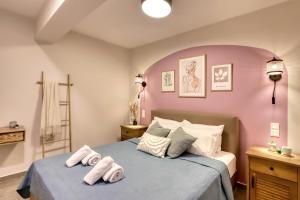 a bedroom with a bed with two towels on it at Eftychia's Cozy Apartment in Sitia