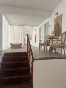 a room with a staircase with a table and chairs at Hotel Azul by MH in Punta del Este