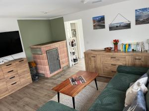 a living room with a couch and a table at Ferienhaus Fjola in Schenkendöbern
