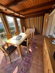 a dining room with a wooden table and chairs at Ferienhaus Fjola in Schenkendöbern +22 photos