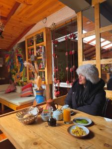a woman sitting at a table with food at Sosa Andina House in Huaraz +48 photos