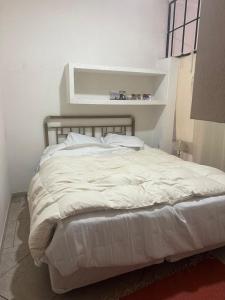 a white bed in a white room with at Loft Junín in Junín