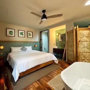 a bedroom with a bed and a bath tub at Musa Hotel Boutique in Bucerías +19 photos