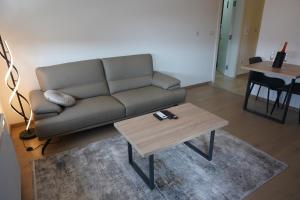 a living room with a couch and a coffee table at Level Apartment in Kostajnica
