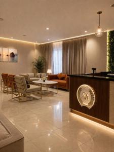 a living room with a couch and a table at فندق الشهباء الفيحاء Hotel Al Shahba Al Faiha Jeddah in Jeddah +19 photos