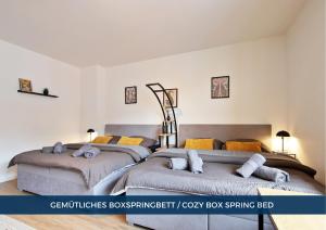 two beds in a room with white walls at RtR Essen - Für bis zu 8 Personen - Voll ausgestattet - Zentral Limbecker Platz - Messe - Uniklinikum - Smart TV - Modern in Essen