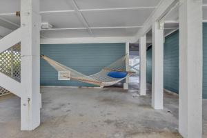 a hammock in a room in a garage at Surviving Stress by Oak Island Accommodations in Caswell Beach