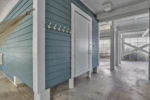 a room with a blue wall and a door at Surviving Stress by Oak Island Accommodations in Caswell Beach +90 photos