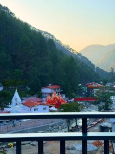 a view of a town with mountains in the background at Kesari Hotel & Restaurant Near Kainchi Dham in Rāmgarh