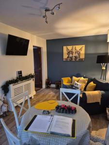 a living room with a table and a couch at Guest Suite in County Limerick in Pallaskenry