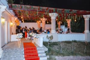 a wedding ceremony in a marquee at night with people at Virginia Gardens in Băile Govora +85 photos