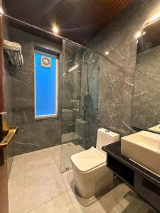 a bathroom with a toilet and a shower and a sink at Kesari Hotel & Restaurant Near Kainchi Dham in Rāmgarh +33 photos