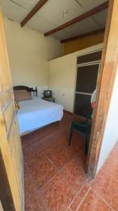 a bedroom with a bed and a chair at Accommodation in Copán Ruinas #5 in Copán Ruinas