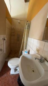 a bathroom with a white toilet and a sink at Accommodation in Copán Ruinas #5 in Copán Ruinas