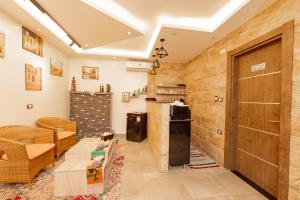 a living room with a wooden door and a couch at Petra Pyramids View in Al Kawāmil Qiblī
