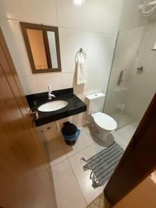 a bathroom with a sink and a toilet and a mirror at Pousada Portal da Mucugê in Porto Seguro +90 photos