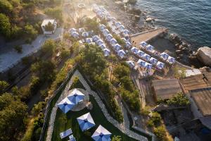 an aerial view of a resort with blue and white umbrellas at Domo20 Hotel & Rooftop in Vico Equense
