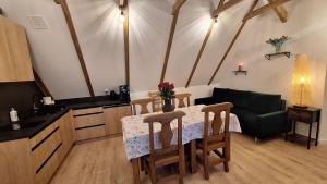a kitchen with a table and chairs and a couch at Domek Julia in Krościenko +45 photos
